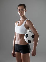 Image showing Woman, portrait and soccer player with ball for match, game or kick off on a gray studio background. Female person or athlete with football for sports exercise, workout or training on mockup space