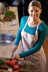 Image showing Food, cooking and woman with vegetables in kitchen cutting ingredients with knife at home. Happy, groceries and portrait of female person with produce for dinner, supper or meal at apartment.