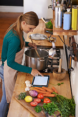 Image showing Woman, cooking and tablet with vegetables for nutrition meal in kitchen or online recipe, diet or connectivity. Female person, home and ingredients with internet or vegan eating, prepare or hungry