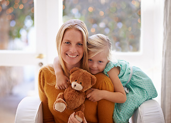 Image showing Happy mama, portrait and hug with child or teddy bear for love, care or support together in living room at home. Face of mom, kid or daughter with smile for embrace, affection or mothers day at house