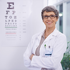 Image showing Woman, senior optometrist and arms crossed for eye care in portrait, test and alphabet chart for vision. Glasses, prescription lens and frame for healthcare, confidence with ophthalmologist at clinic