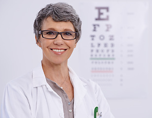 Image showing Portrait, senior woman and optometrist smile for eye care, letter chart for exam with doctor at clinic. Alphabet, glasses for vision and prescription lens, assessment and ophthalmology for spectacles