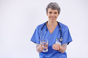 Image showing Mature woman, doctor and water with pills, healthcare with medication treatment and supplements on white background. Vitamins, medicine and pharmaceutical drugs with physician for health in studio