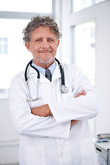 Image showing Senior man, doctor and portrait with arms crossed in office for healthcare, medical support and medicine career. Mature, face and health expert with smile or confidence with stethoscope in hospital
