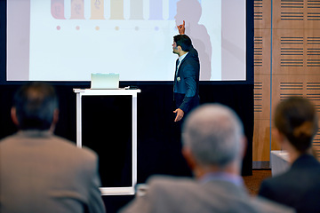 Image showing Businessman, presentation and podium with projector at conference in team meeting, staff training or seminar. Man, employee or speaker talking to group or audience with screen at corporate workshop
