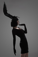 Image showing Girl, feather and head for fashion in studio for fantasy or magic with unique creativity for art or illusion. Female person, isolated and white background for designer clothes, diva and surreal.