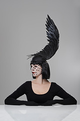 Image showing Fashion, woman and feather cap in studio with thinking for glamour, style with confidence. Female person, birdcage veil and cap with wing for elegance, designer clothes and luxury on gray background