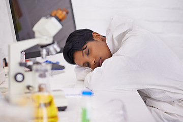 Image showing Sleeping, tired and woman scientist in laboratory working overtime on pharmaceutical research. Exhausted, fatigue and female biology researcher with nap for burnout with medical project or study.