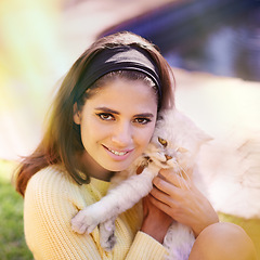 Image showing Woman, cat and embrace outdoors in portrait, pet care and smile for affection in backyard or garden. Female person, animal and hug for bonding on vacation or holiday, happy and companion for support