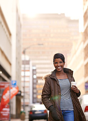 Image showing City, fashion and portrait of woman, walking and coffee or tea, sunglasses and happy. Adult, female person and girl with smile with jacket or coat in Cape Town, shades and drink on hand in street