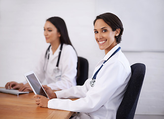 Image showing Portrait, doctor and happy woman with tablet in hospital for healthcare, wellness or coworking online. Face, smile or medical professional with technology at desk, employee or expert team in clinic