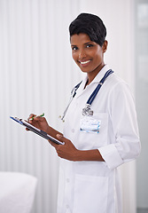 Image showing Portrait, doctor and happy woman writing on checklist in hospital for healthcare career in India. Face, smile and medical professional with clipboard, employee or expert worker in clinic for wellness