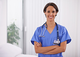 Image showing Face, nurse and happy woman with arms crossed in hospital for healthcare, wellness and service. Portrait, smile and confident medical professional surgeon, employee and doctor in clinic in Brazil