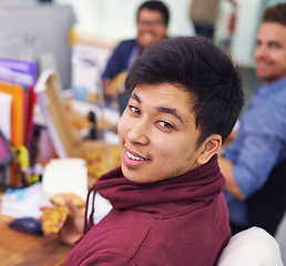 Image showing Businessman, portrait and eating with smile in office for lunch break, pizza and coworking company. Programmer, asian employee and face or happiness with fast food, coding team and working at desk