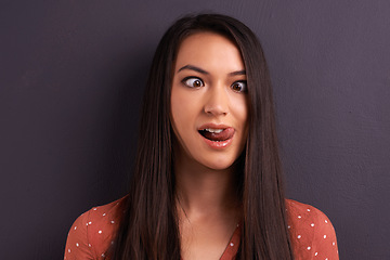 Image showing Woman, funny face and studio for comedy tongue out or mockup space, grey background or humor. Female person, model and crazy emoji as meme for comic reaction with goofy good mood, carefree or squint