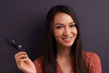 Image showing Woman, portrait and glasses in studio for vision prescription with confident smile, grey background or mockup space. Female person, eyewear and frame for healthy optometry, eye care or spectacles