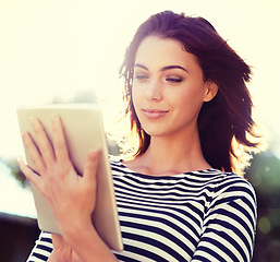 Image showing Woman, nature and smile in sunshine with tablet for digital communication, social media or reading blog. Happy, female person and technology outdoors for internet, connection and game with low angle