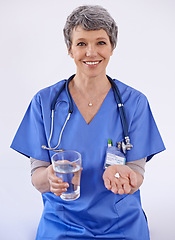 Image showing Senior woman, doctor and water with pills, healthcare with medication treatment and supplements on white background. Vitamins, medicine and pharmaceutical drugs with physician for health in studio