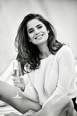 Image showing Champagne, glass and portrait of woman with smile for vacation, weekend break and relax on holiday. Female person, alcohol and face with happiness for getaway, summer trip or recreation in monochrome
