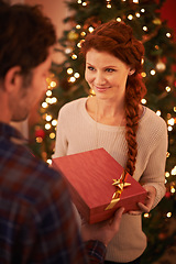 Image showing Couple, Christmas and gift for holiday celebration, festive and season of giving for love and commitment. Happy, gratitude and support with people at home for present, romance and relationship