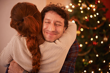 Image showing Couple, Christmas and hug to celebrate holiday, festive season of giving for love and commitment. Happiness, gratitude and support with people at home, romance and relationship with peace together