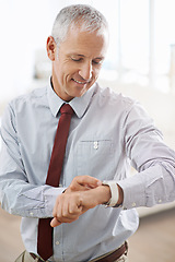 Image showing Happy, smile and senior businessman with smartwatch in office for message, notification or text check. Tech, reading and elderly executive with digital watch, schedule or effective time management