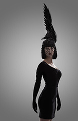 Image showing Woman, feather and art for fashion in studio for fantasy or magic with unique creativity for art or illusion. Female person, isolated and white background for designer clothes, diva and surreal