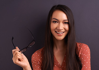 Image showing Woman, portrait and glasses in studio for eye care prescription with confident smile, grey background or mockup space. Female person, vision and frame for healthy optometry, eye care or spectacles