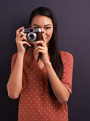 Image showing Happy woman, portrait and photography with camera for memory or picture on a dark studio background. Young female person or creative journalist with smile for photo, moment or capture for startup