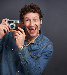 Image showing Portrait, man or vintage camera in fashion, photography or capture of creative, graphic or style. Male photographer, retro gadget or film in trendy, stylish or denim in studio on grey background