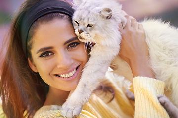 Image showing Woman, cat and holding outdoors in portrait, pet care and smile for affection outside. Female person, animal and embrace for bonding on vacation or holiday, happy and companion for support or joy