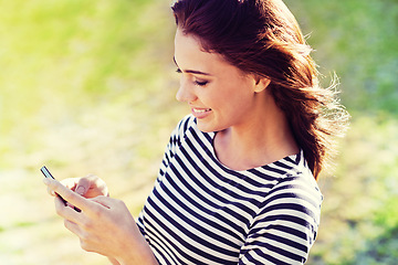 Image showing Happy woman, cellphone and social media for networking in city and typing a message for connection. Lady, smartphone and scroll for online shopping or reading email and update on holiday in england