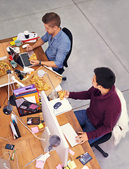 Image showing Business people, men and working while eating with top view for deadline, pizza and coworking company. Programmer, teamwork and technology on lunch with fast food, coding and software development