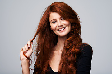 Image showing Woman, haircare and smile with redhead in studio on white background with satisfied look and confidence. Portrait, female person and happy with treatment for routine, repair and soft for beauty