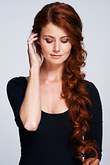 Image showing Beauty, haircare and cosmetic treatment for female person, spa and salon on studio background. Curly, healthy hair and texture for Scottish woman model, hand and keratin for redhead or ginger lady