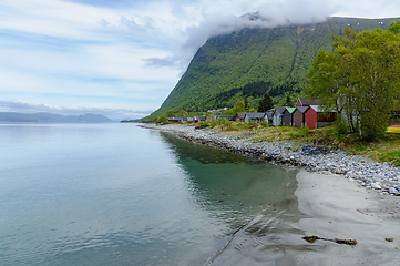 Image showing Serene morning by the fjord with colorful fishing cabins in norw