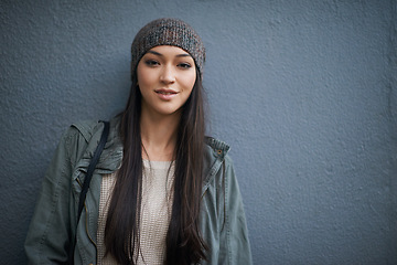 Image showing Woman, beanie and jacket with portrait, confidence and urban fashion or street style. Female student, denim and cold with trendy, winter and cape town adventure or holiday on grey wall background