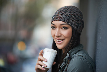 Image showing Thinking, city and smile with woman, coffee and relaxing with winter season and wool cap. Cold weather, person or girl with tea and cappuccino with urban town or knitted beanie with happy in a street