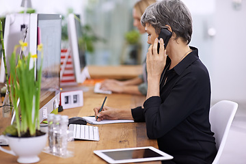 Image showing Business woman, phone call and manager writing notes, communication or listen in startup. Mature professional, cellphone and conversation for book, info and creative designer on computer at desk