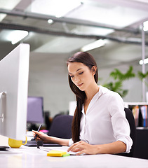 Image showing Woman, office and computer in desk with schedule for work with sticky notes, paper and pen for administration. Assistant, female person and confident with pc for internet or website for search.