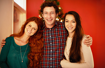 Image showing Christmas, portrait and happy family in embrace, love and winter celebration by red background. Father, other and adult child and smile on face for holiday season, care and bonding together in home