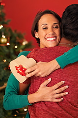 Image showing Friends, hug and Christmas with surprise, gift box and celebration on red studio background. Face, people or woman with Xmas present or parcel with embrace or excited with package or bonding together