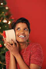 Image showing Christmas, excited and woman guess gift in box at home for holiday celebration on mockup space in India. Happy person, xmas and shaking present or listening to package for festive season in house