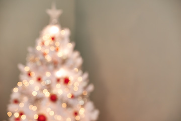 Image showing Christmas, tree and decorations in living room with blur, holiday or preparation for festive season. Morning, bokeh and tradition for celebration, xmas and December winter vacation in apartment