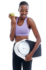 Image showing Fitness, apple and scale with happy black woman in studio isolated on white background for weight loss. Exercise, smile and diet with confident young sports model training for health or nutrition