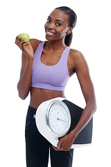 Image showing Portrait, apple and scale with fitness black woman in studio isolated on white background for weight loss. Exercise, smile and diet with happy young sports model training for health or nutrition