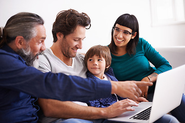 Image showing Family, laptop and learning or streaming on sofa, smile and bonding in living room. Video call, internet and chat with grandfather pointing, parents and young boy for communication online in home