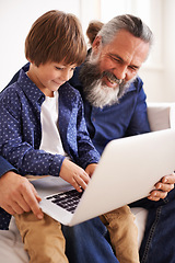 Image showing Grandfather, laptop and boy child for streaming, elearning and bonding in living room. Focus, family and internet for play and son typing, childhood development and games or technology for learning