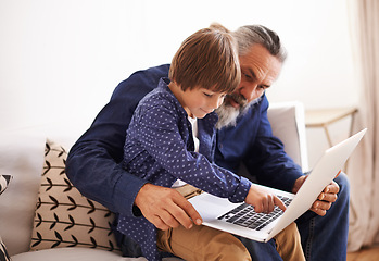 Image showing Grandfather, son and laptop in lounge with love and bonding together with cartoon in living room. Happy family, boy and computer for choice of online games, holiday and movie subscription in home