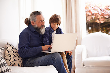 Image showing Laptop, education or game with grandfather and child, growth and development in living room. Technology, elearning or grandpa on sofa in family home, streaming or online and internet with elderly man